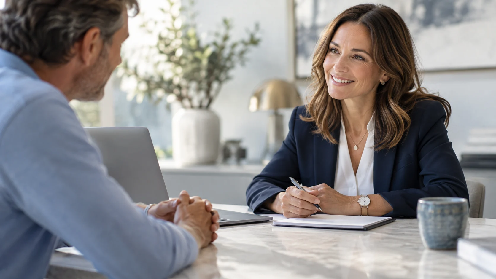 Customer and adviser meeting across a desk in a welcoming office